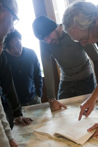 Sailors looking at a map - Sailing Lessons - Coastal Navigation