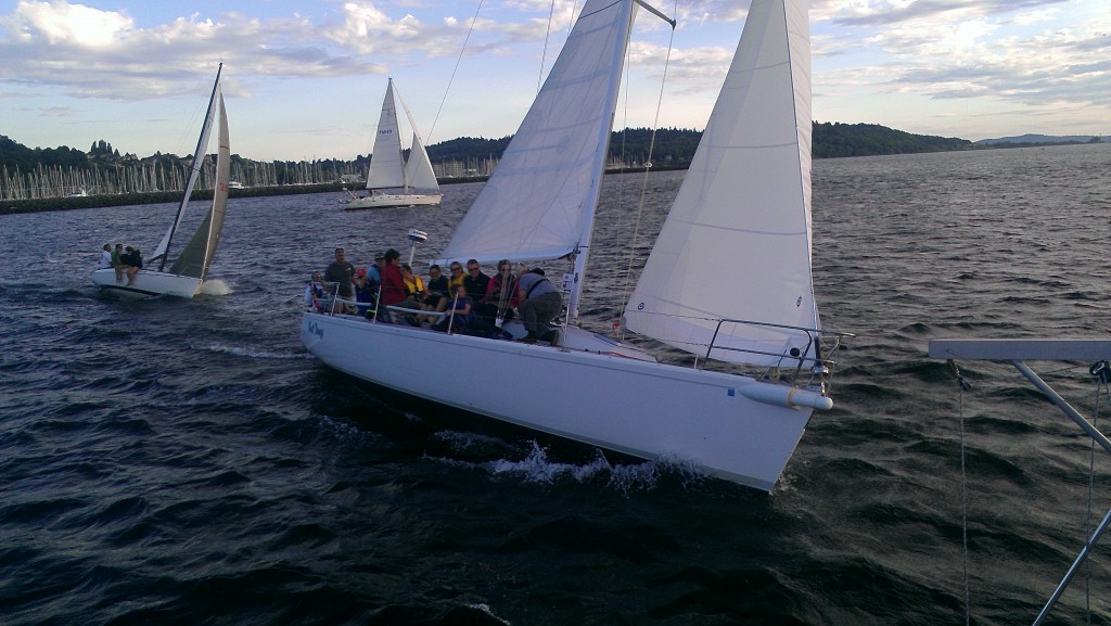 Group of people on a tilted sailboat