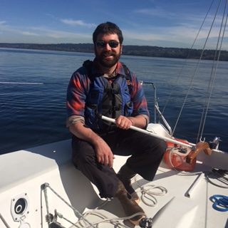 Man on a sailboat - Sailing Lessons - ASA 101